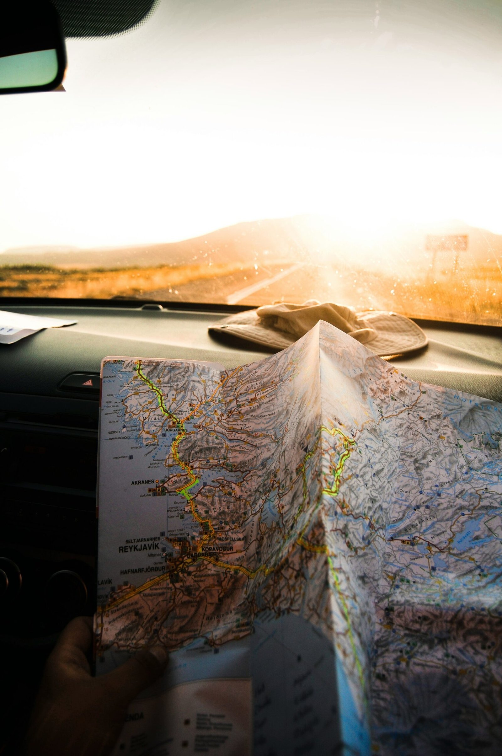 person holding blue and brown map